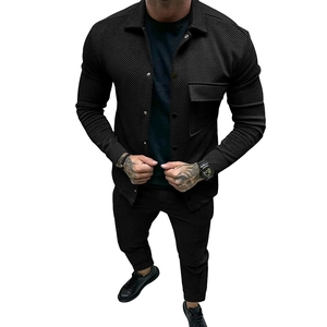 Close-up of premium black twill fabric texture and chest pocket on men's casual jacket