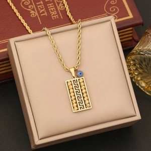 Golden geometric necklace with evil eye pendant on rope chain, elegant display box