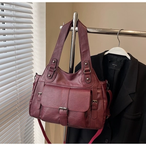 Detailed close-up showing the soft leather texture of the large commuter handbag
