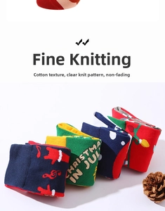 Detailed view of knitted cotton Christmas socks with musical notes and festive patterns