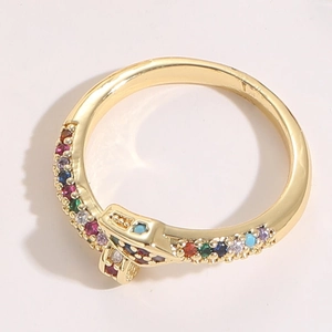 Detail view of gold snake ring featuring vibrant colorful zircon stones and crystals