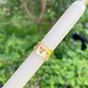 Macro shot of a wavy 18K gold plated mesh ring with sparkling zircon stone settings