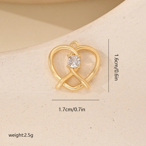 Detailed view of a gold heart pendant with zircon, showing 1.6cm x 1.7cm dimensions