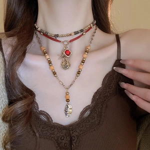 Bohemian multilayer necklace with wooden beads and crystal pendants on model
