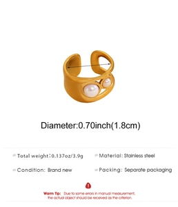 Detailed view of gold stainless steel open ring with hollow design and white pearls