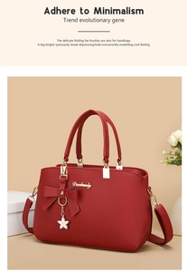 Close-up of red PU leather handbag with lychee texture and bow star pendant