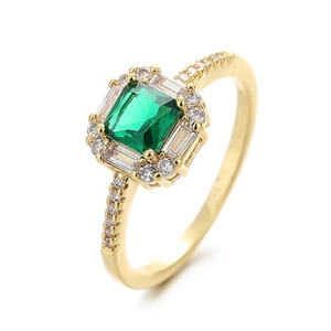 Detail view of a gold-plated ring with square green gemstone and zircon accents