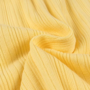 Gros plan sur la texture du tricot côtelé jaune doux avec motifs verticaux
