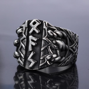 Macro detail of Viking Rune ring with Celtic knotwork patterns and aged steel finish