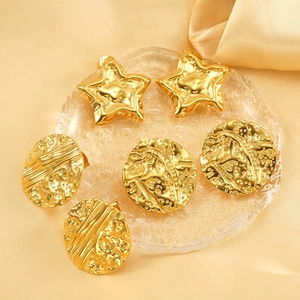 Vintage 18K gold plated stainless steel star and round textured earrings on silk