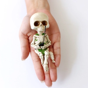 Halloween fishing skeleton resin ornament held in hand for home spooky indoor outdoor decor