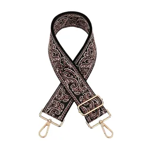 Detail view of ethnic paisley jacquard strap with adjustable light gold metal buckles