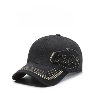 Detail of classic letter embroidery and stitched brim on a black vintage baseball cap