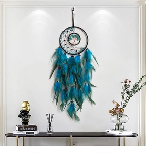Detailed view of turquoise Tree of Life dreamcatcher hanging on a white wall above a console table