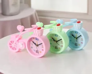 Close-up of heart-shaped bicycle clocks in pink, blue, and green macaron colors