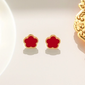 Red five-petal flower stud earrings with gold plating on a minimalist background