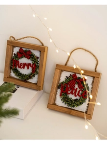 Detail of Christmas wooden wreath sign with Merry and Peace lettering and plaid bow