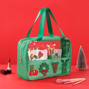 Detail of green chenille letter LOVE embroidery on Christmas toiletry bag for makeup