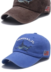 Detail of washed cotton baseball caps with shark embroidery and US flag patch