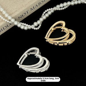 Detailed view of hollow heart metal hair claws in gold and silver colors, 5.5cm size