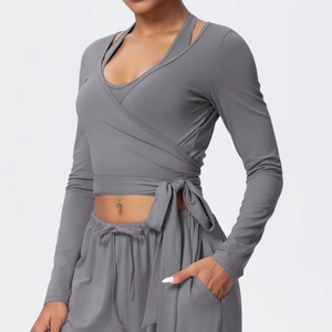 Detail of gray wrap yoga top with waist ties and matching high-waist joggers set