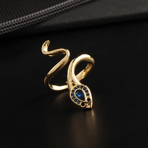 Close-up of golden snake ring with blue zircon stones and detailed scale texture