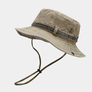Detail of washed cotton outdoor hat with side metal eyelets and adjustable chin strap