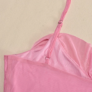 Detail of pink mesh fabric texture and adjustable spaghetti strap on a summer dress