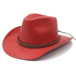 Red straw cowboy hat with wide brim and studded leather band, 45-degree angle view