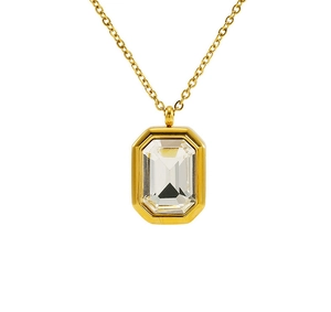 Macro shot of gold square zircon pendant with step-cut crystal on elegant thin chain