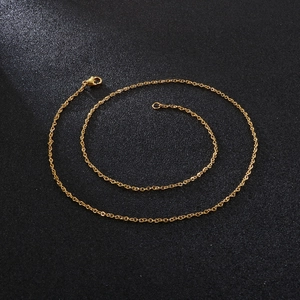 Detailed macro view of a gold-toned cable chain with a classic lobster clasp closure