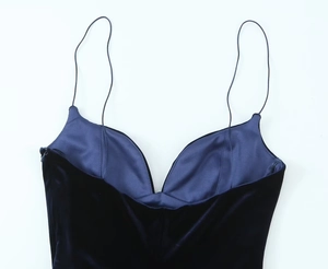 Detail of dark blue velvet bodysuit featuring V-neckline and delicate spaghetti straps