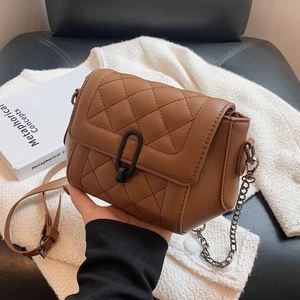 Brown quilted leather crossbody bag with chain strap and black metal clasp hardware