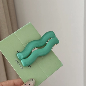 Set of two wavy mint green hair clips on handmade card for women's styling