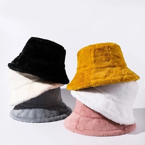 Détail montrant plusieurs couleurs de bobs en peluche hivernale avec texture douce