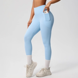 Detail of high waist yoga pants showing functional side pocket holding a smartphone