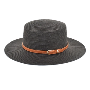 Detail of black woven straw boater hat featuring a brown faux leather band with buckle