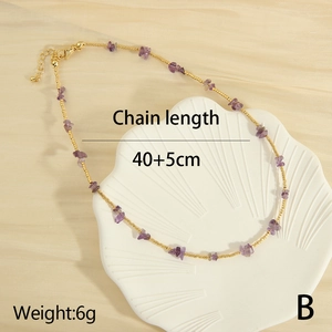 Detail of purple crushed stone and gold bead necklace on shell tray, 40+5cm length