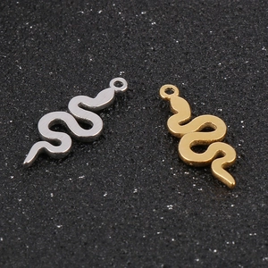 Detailed view of snake-shaped stainless steel charms in silver and gold metal finishes
