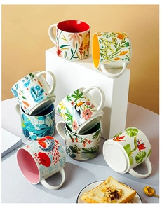 Detailed view of assorted ceramic mugs featuring various floral patterns and colorful glazes