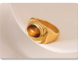 Detailed view of vintage gold-plated oval tiger eye stone ring with textured metal edge