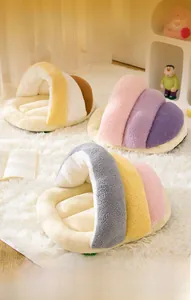 Detail view of semi-enclosed plush pet beds in three colors on a soft white carpet