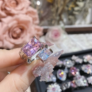 Detailed close-up of pink and white rectangular zircon double stone ring on silver band
