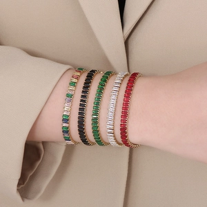 Close-up of 18K gold plated bracelets featuring colorful rectangular zircon insets
