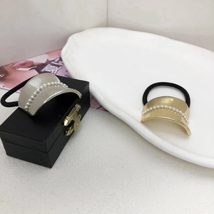 Minimalist alloy hair tie with metal curved plate and pearl detail in gold and silver