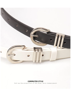 Detail of minimalist black and white leather belts with silver metal buckles and tri-bar loops