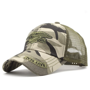 Macro detail of Navy SEAL emblem embroidery on camo mesh tactical baseball cap