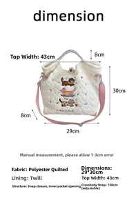 Quilted tote bag dimension guide with cat embroidery and adjustable shoulder strap