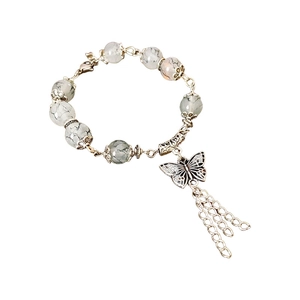 Bracelet vintage avec pendentif papillon, perles marbrées et pompons en métal argenté