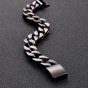 Macro shot of gunmetal black Cuban link bracelet with wide industrial rectangle clasp